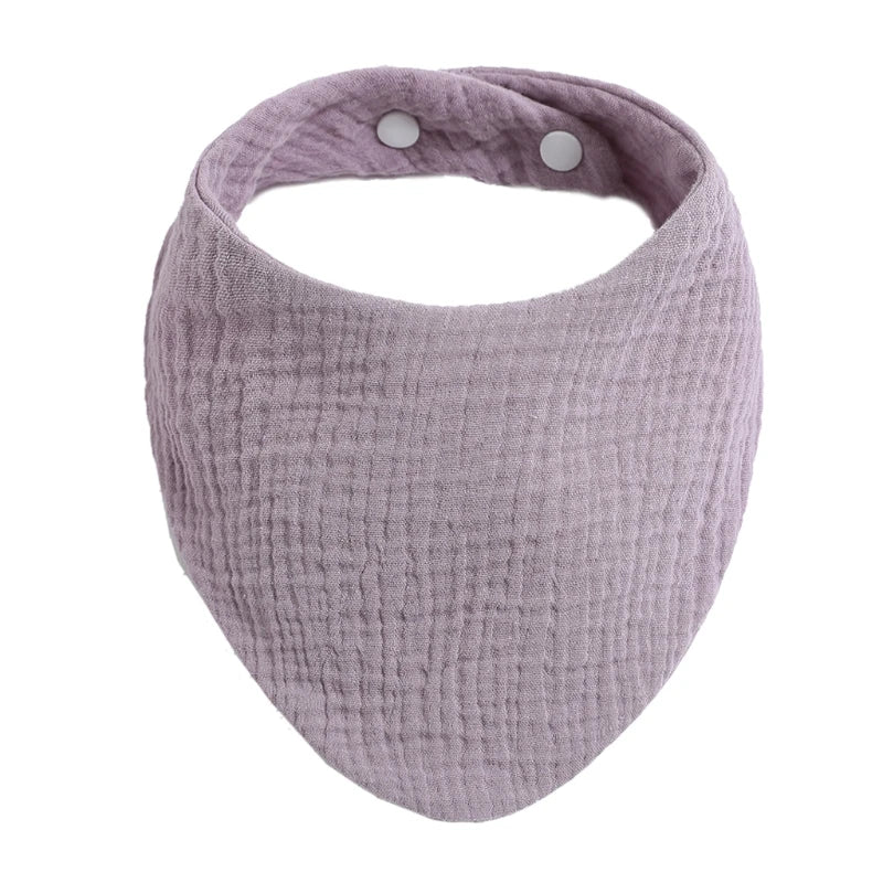 A light purple organic cotton muslin baby bib with an absorbent band around the neck.