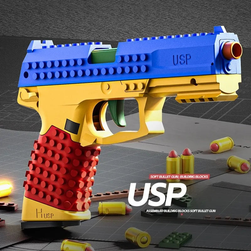 A yellow and blue USP building block toy pistol with a red shell casing, shown in a close-up view.