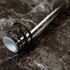 Roll of waterproof self-adhesive marble wallpaper featuring dark gray and white veining on a dark surface.