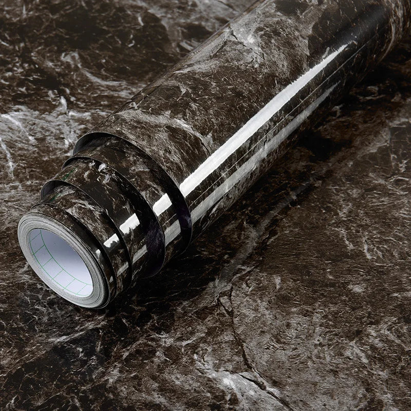 Roll of waterproof self-adhesive marble wallpaper featuring dark gray and white veining on a dark surface.