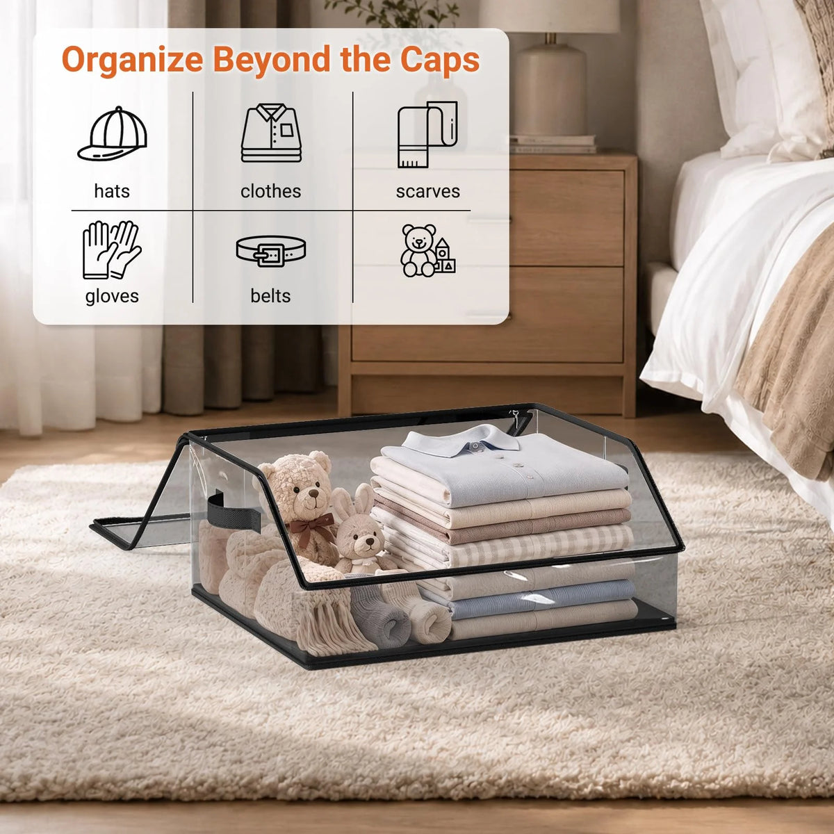 A clear acrylic organizer tray holds various items like hats, clothes, scarves, gloves, and belts on a beige rug.