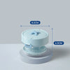 A light blue portable denture case with a lid and storage for a cleaning brush, shown from above.