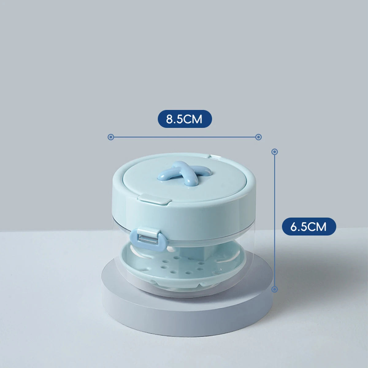 A light blue portable denture case with a lid and storage for a cleaning brush, shown from above.