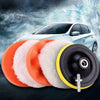 A set of six orange and white polishing pads with a drill adapter shown in front of a light-colored car.
