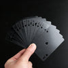 A hand holds a fan of black playing cards, showing the numbered cards from 2 to 10.