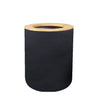 A black cylindrical bathroom organizer set with a bamboo top and soap dispenser.