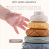 A hand is interacting with a stack of silicone rubber rings featuring various embossed and concave-convex relief textures for