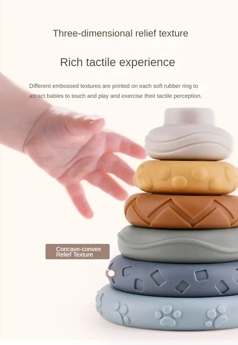 A hand is interacting with a stack of silicone rubber rings featuring various embossed and concave-convex relief textures for