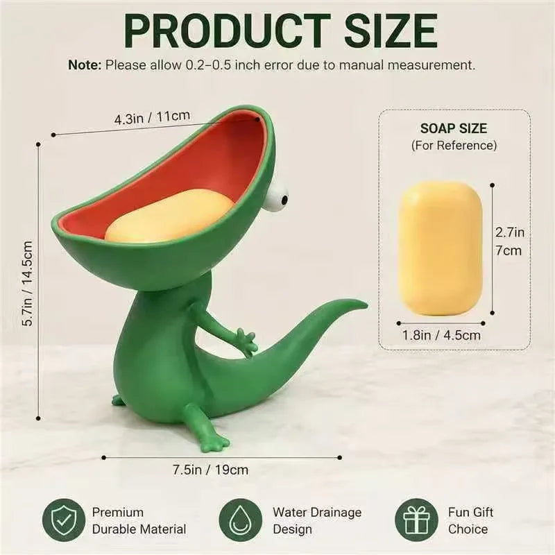 A green lizard-shaped soap holder with an open mouth design, showing its size relative to a yellow bar of soap.