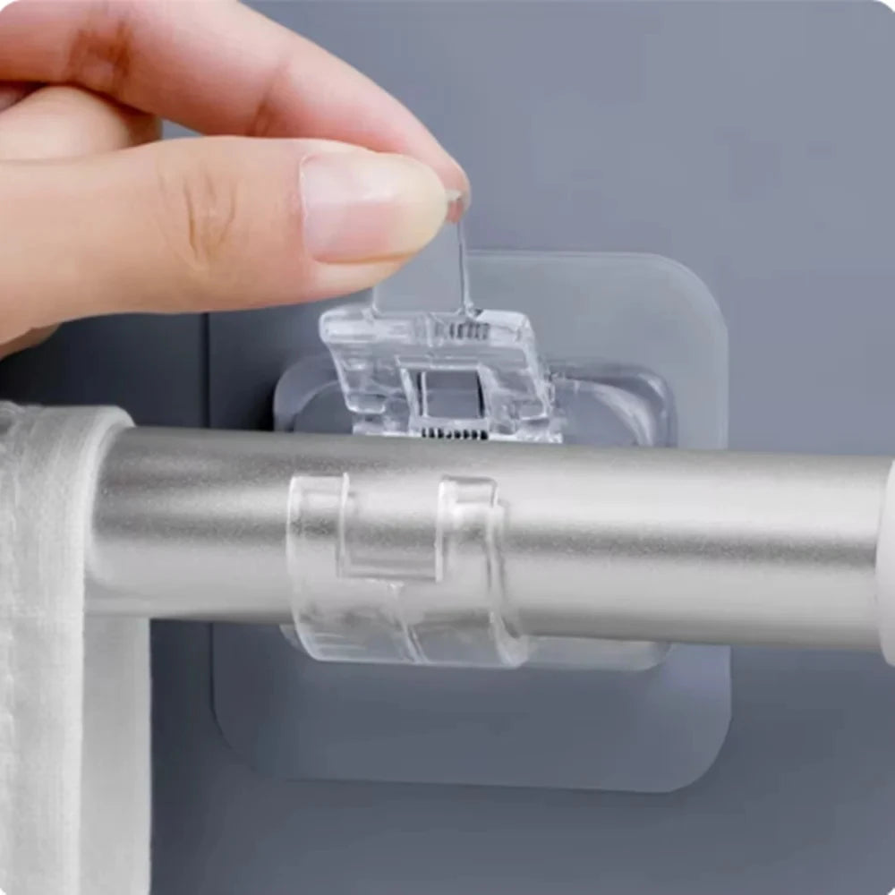 A hand is inserting a clear adhesive hook into a silver curtain rod, demonstrating the self-adhesive curtain rod hooks.