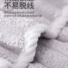 Close-up of a white microfiber towel showing its soft texture and woven pattern.