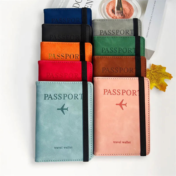 A stack of vintage RFID passport holders and a travel wallet in various colors, including blue, black, orange, green, and pin