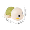 A light beige wind-up swimming turtle bath toy with a green shell and yellow accents.