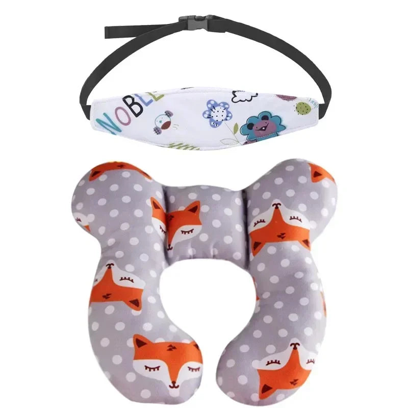 A gray and white patterned baby head and neck support pillow with an attached safety strap.