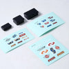 A set of black RC car decorative accessories including a surfboard, kayak, and roadblocks
