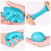 Hand holding a bright turquoise reusable cleaning gel for car interiors and electronics