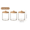 Three clear acrylic storage tanks with bamboo lids for bathroom storage