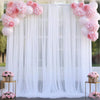 Pink and white tulle curtains forming an elegant backdrop for an event or photo shoot.