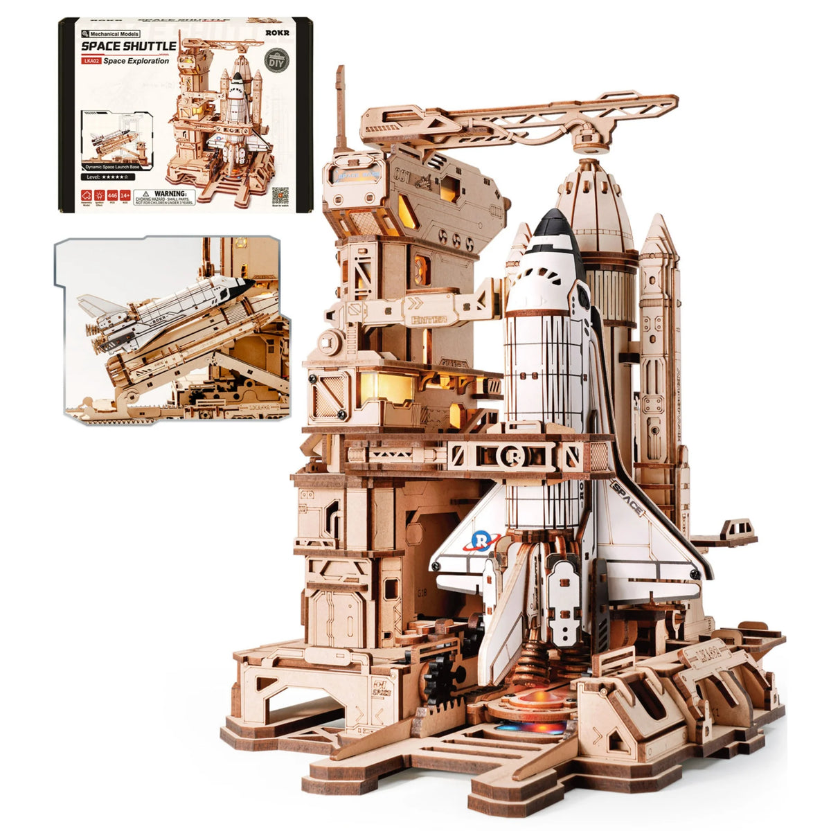 A detailed wooden model kit of a space shuttle and launch simulator structure.