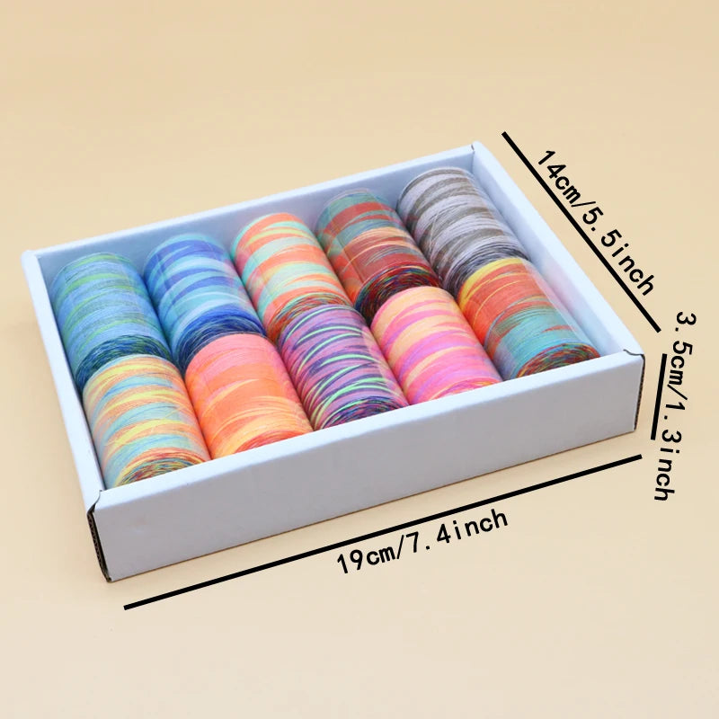 A box containing a collection of rainbow colored polyester thread spools, laid out for sewing.
