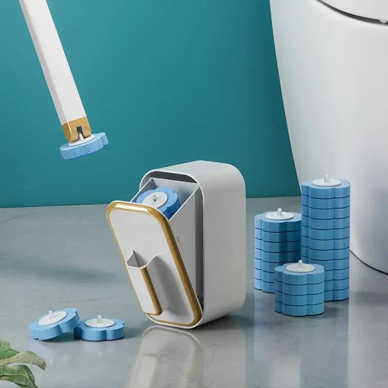 A white disposable toilet cleaning brush holder with blue replacement heads on a gray surface.