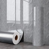 Roll of self-adhesive marble wall sticker for kitchen and bathroom displayed against a gray tiled wall.