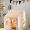 A white princess castle play tent with a pitched roof and decorative bunting hangs on a light gray wall.