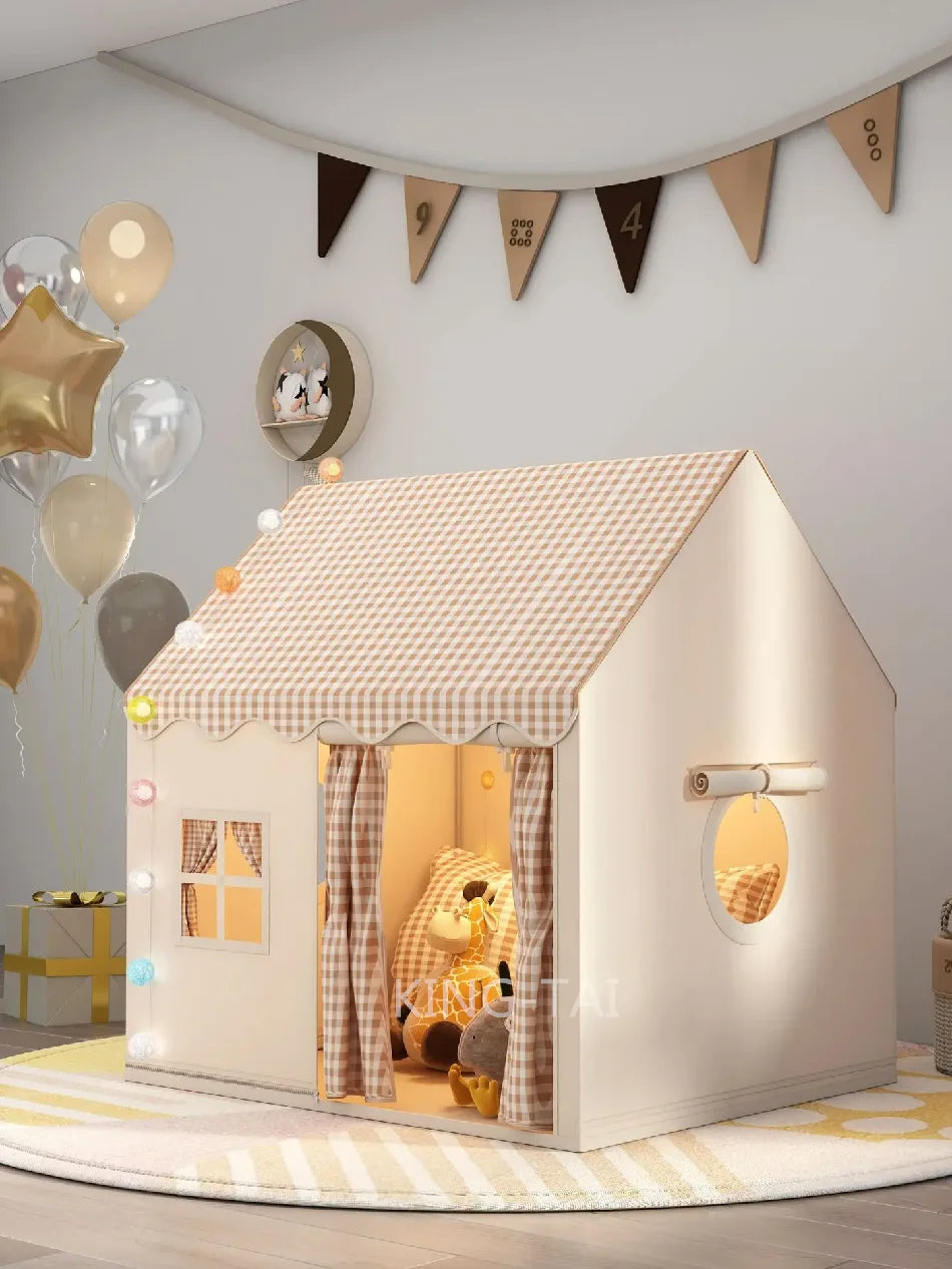 A white princess castle play tent with a pitched roof and decorative bunting hangs on a light gray wall.