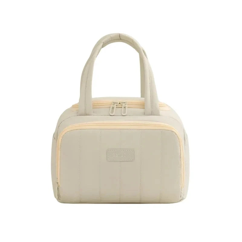 A beige quilted insulated lunch tote bag with a handle and zipper details.