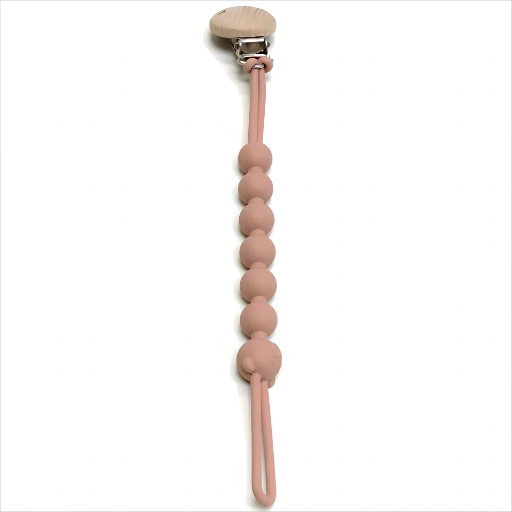 A food-grade silicone pacifier clip with an anti-lost chain, featuring a light pink color and a wooden top.