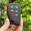A hand holds a black silicone key fob cover with multiple buttons for Chevy, GMC, and Buick models.