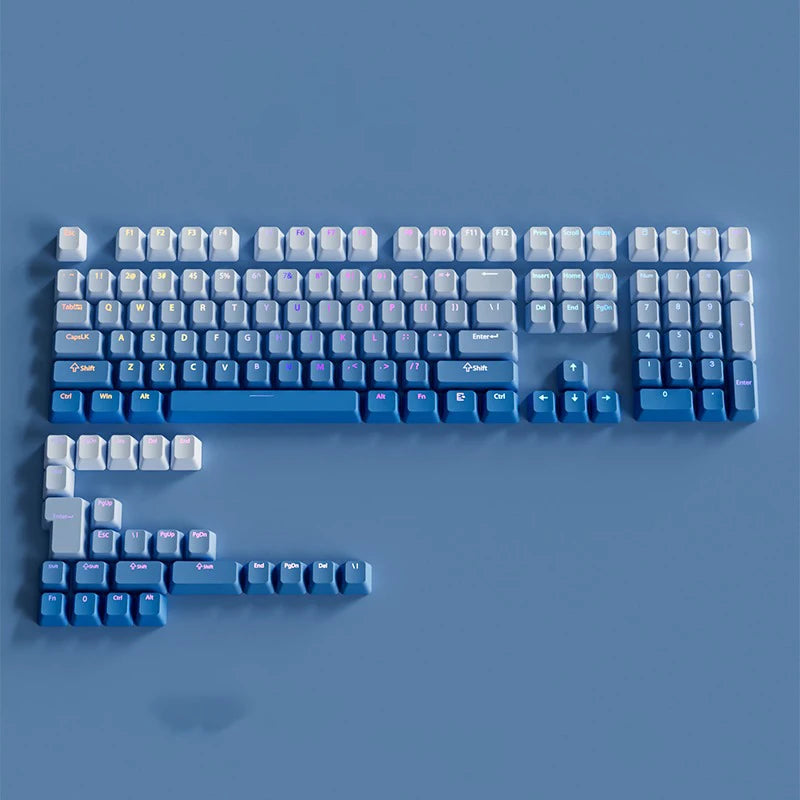 A set of PBT double-shot keycaps with gradient colors arranged in a rectangular and L-shaped layout.