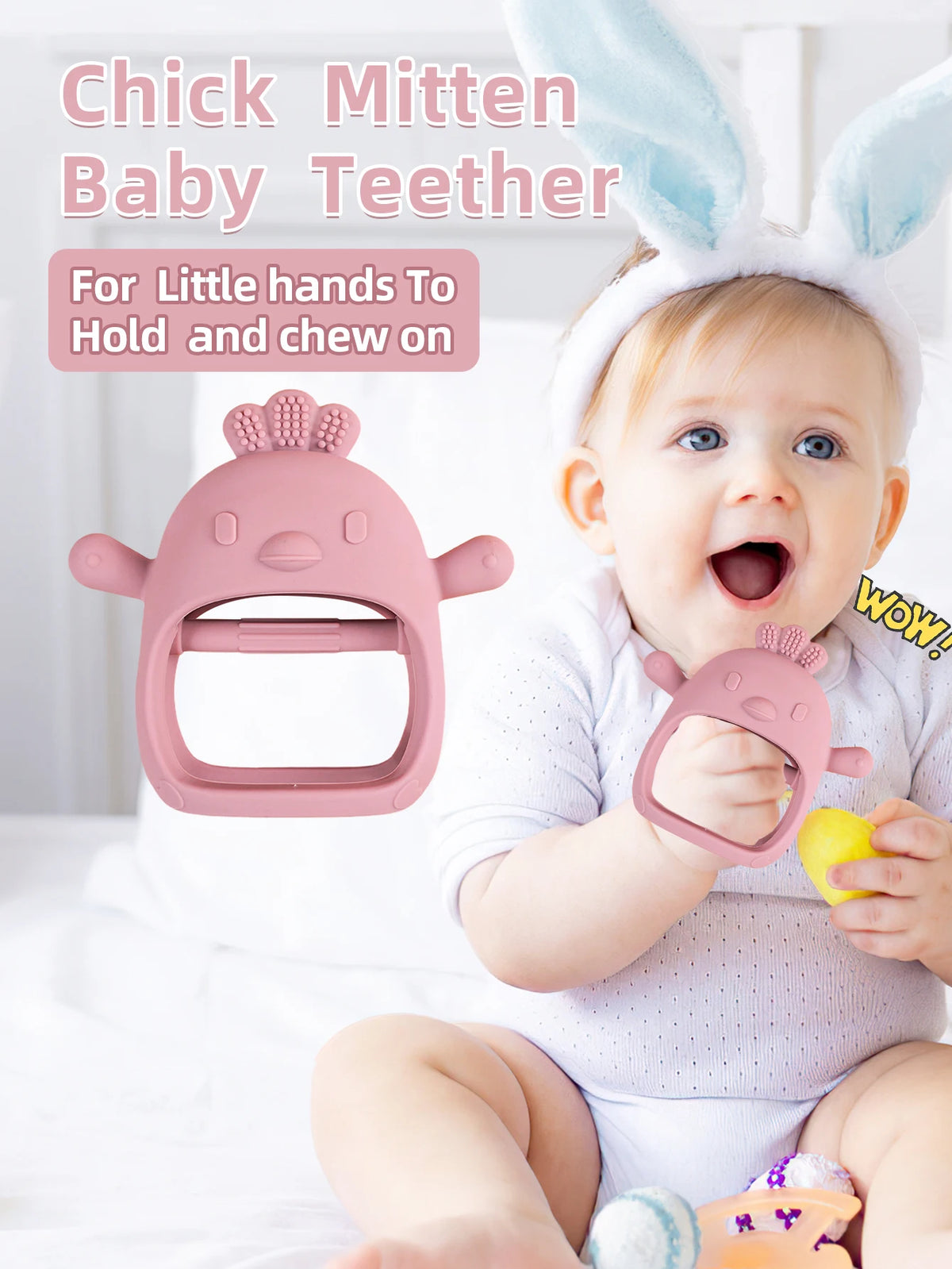 A baby is holding a pink silicone chick mitten teether designed for little hands to hold and chew on.