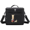 Black insulated canvas lunch bag with a gold letter T design and adjustable strap.