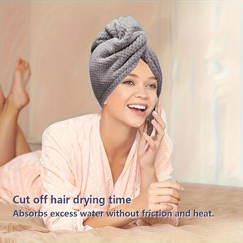 A woman is shown using a towel wrap on her hair while talking on the phone.