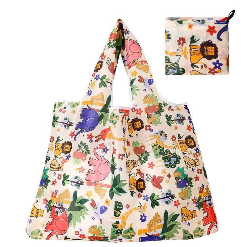 A reusable shopping tote bag featuring a floral pattern with various colorful illustrations and a matching small carry pouch.