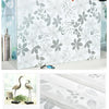 Roll of frosted privacy window film featuring a gray and white leaf stripe pattern