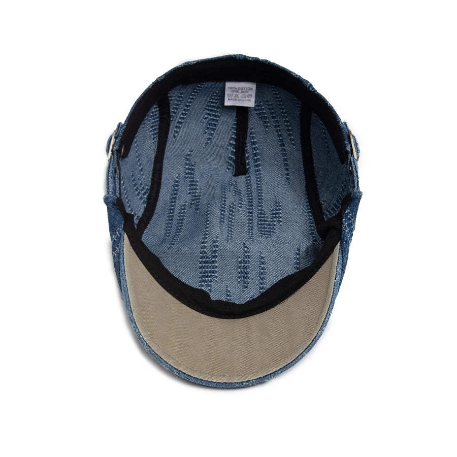 A vintage plaid cotton beret shown from the top, featuring blue fabric and a tan lining.