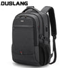 A black DUSLANG laptop backpack featuring a USB charging port and padded straps.