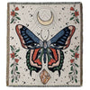 A woven throw blanket featuring a detailed butterfly design in earthy tones and floral accents.
