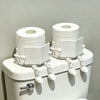 White human-shaped freestanding toilet paper holder with rolled white toilet paper.