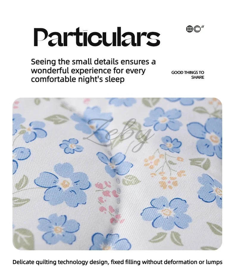 Close-up of a light blue floral quilted fabric featuring small details for comfortable sleep.