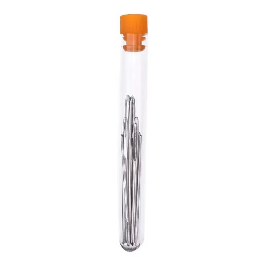 A clear plastic container holding large eye sewing needles for yarn, embroidery, and beading.