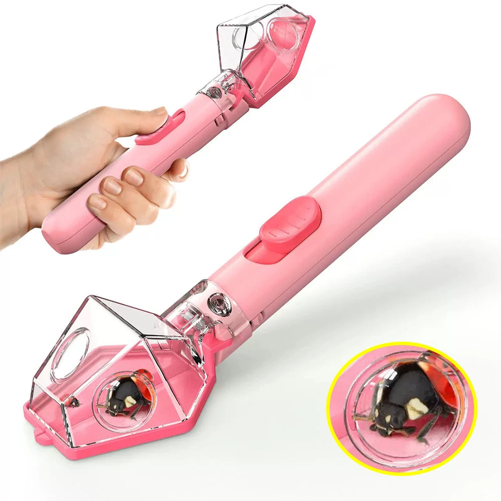 A pink eco-friendly bug catcher and magnifying viewer for kids being held by a hand, with a close-up view of a bug inside.