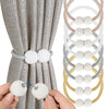 Pearl magnetic curtain tiebacks with strong hold used to secure a gray fabric curtain.