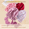 A collection of silk satin sleep bonnets in contrasting colors including pink, red, and blue patterns.