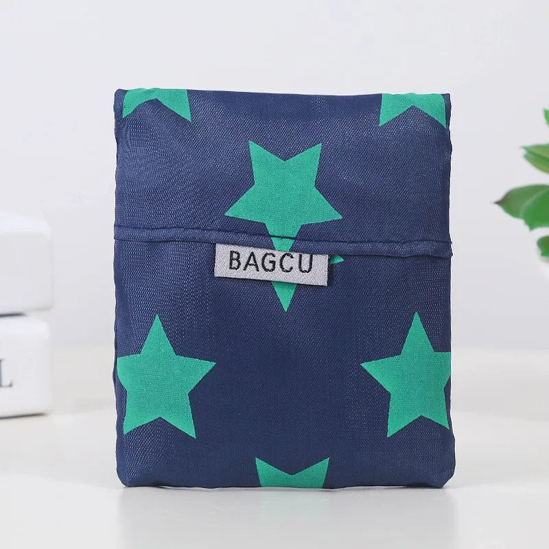 A dark blue fabric pouch patterned with bright green stars.