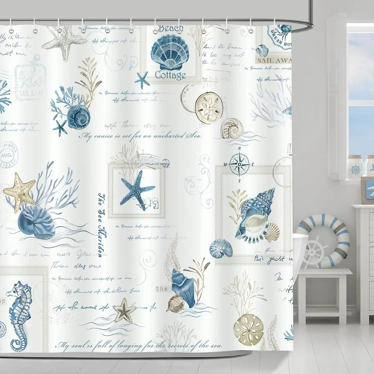 A white shower curtain featuring a blue and gold nautical design with starfish, shells, and sea motifs.