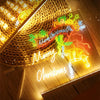 An LED drawing board with seven pens and a night light illuminating Christmas-themed drawings on a wooden surface.