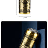 A vertical shot of a gold-colored electric razor with a Buddha face design, showing its length and detail.